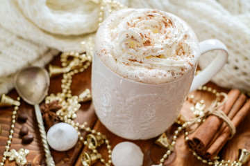 Christmas cup with  whipped cream on a Christmas decoration background