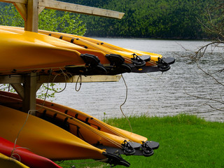 Red and yellow kayaks stored outside