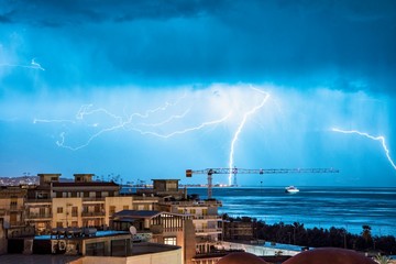 Naklejka na ściany i meble Strait of Messina lightning bolt city background 