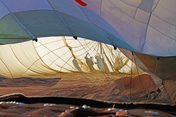 Inside hot air balloon with shadows of people outside