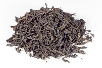heap of black tea isolated on white background