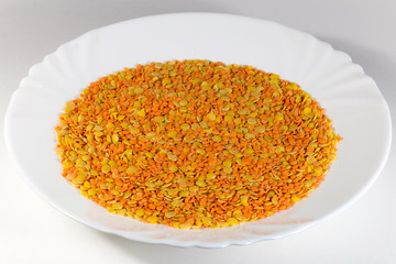 White plate with mix of red and green lentils