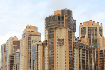 Architecture of Residential Apartment Buildings in Downtown of St. Petersburg City, Russia. Skyscraper Facade of Modern Office Building, New Complex of High Houses with Empty Cloudy Sky Background 