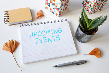 upcoming events written in a notebook on white table
