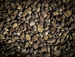 the texture of small light and dark stone pebbles