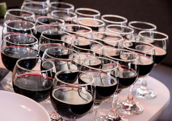 Rows of red wine glasses for party and wedding