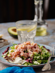 Ceviche is a traditional dish from Peru. Salmon marinated in lemon with fresh lettuce, avocado and onions