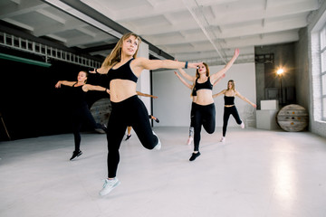 Naklejka premium Team of women having step aerobics class