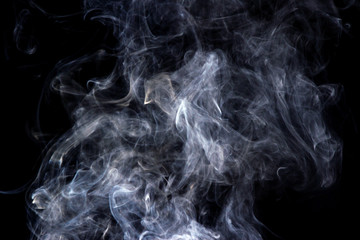 Thick smoke on a black isolated background. Background from the smoke of vape