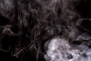 Thick smoke on a black isolated background. Background from the smoke of vape
