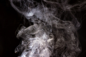 Thick smoke on a black isolated background. Background from the smoke of vape