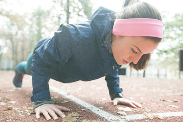 Sporty WoMan Doing Push Ups At Outdoor Fitness Park