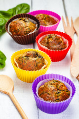 Muffins with basil and spinach on wooden rustic table. Close up