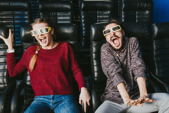 guy and girl 3d glasses are very worried while watching a movie in a cinema