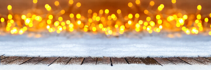 christmas xmas snow bokeh background with many lights and empty ice blue snow copy space /...