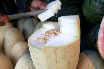 Person cuts melon