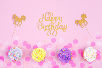 Creative pastel fantasy holiday card with cupcake, happy birthday lettering and unicorn. Baby shower, birthday, celebration concept.
