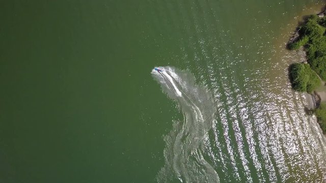 Top down aerial view of person having fun on a jet ski