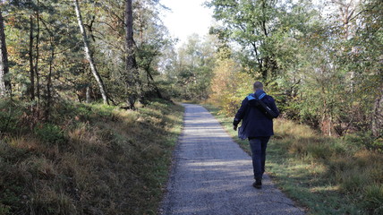 Man walking down the street during fall