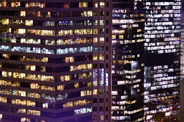 Office building at night. Late night at work. Glass curtain wall office building