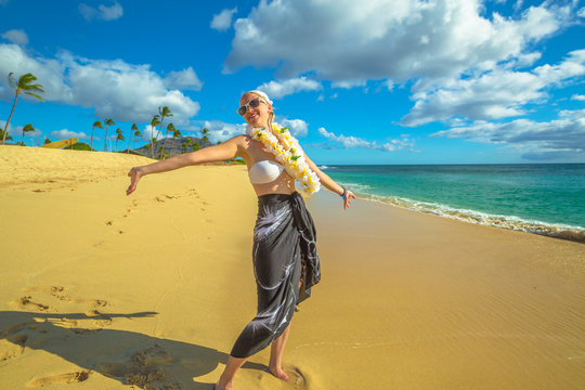 Woman with flower neck garland. Freedom bikini woman in Makua Beach, Waianae coast, Hawaii. Makua Valley, Oahu island.