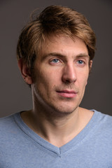 Obraz premium Portrait of handsome man against gray background