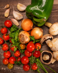 different  fresh vegetables in a vintage wood table