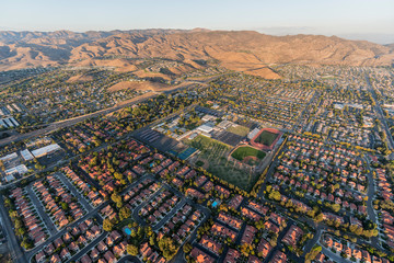 Aerial view of modern suburban housing, the 118 freeway and Rocky Peak Mountain Park near Los Angeles in Simi Valley, California.