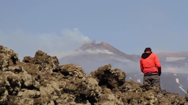 Geologist on Volcano Etna - Eruption with explosion and lava flow in Sicily