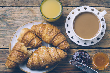 Black coffee and croissant with jam. Typical French Breakfast (Petit Déjeuner) background.