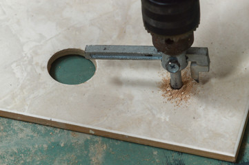 The process of cutting tiles in construction. Work as a grinder