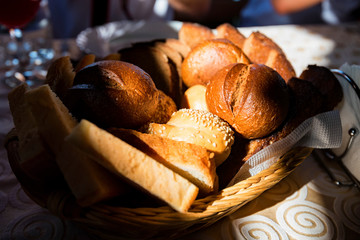 Assorted fresh bread in basket close view