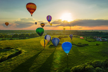 Many hot air balloons at sunset sky background	