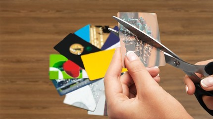Cutting up credit card with scissors