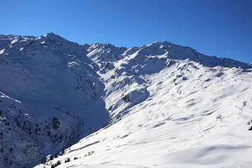 Fototapeta na wymiar Wintery mountain landscape with sunshine