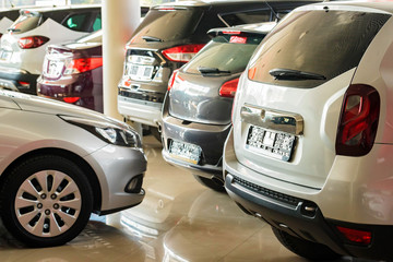 New cars at dealer showroom blurred background interior