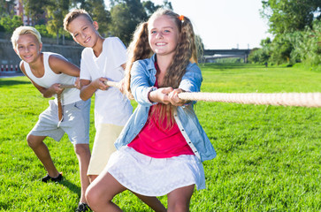 Children playing tug of war outdoors