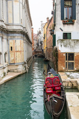 Fototapeta na wymiar Gondola in a little canal of Venice
