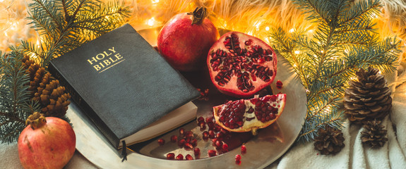 Fruits and vegetables for harvesting. Still life - bible and pomegranate on an iron plate in the...