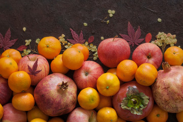 Italian autumn harvest: garnet, mandarins, persimmons, apples.
