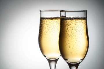 Two elegant glasses with sparkling champagne