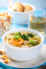 Italian vegetable soup with broccoli carrots and noodles in chicken broth