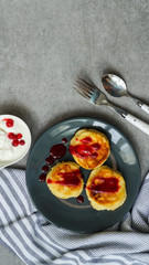 cottage cheese pancakes, tasty healthy breakfast, top view, grey stone background