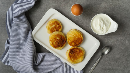 cottage cheese pancakes, tasty healthy breakfast, top view, grey stone background