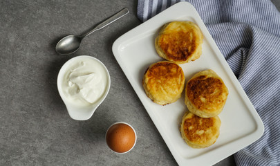 cottage cheese pancakes, tasty healthy breakfast, top view, grey stone background