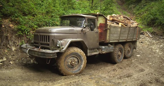 Antique Russian Army Truck Loaded with Logs in Ukrainian Forest