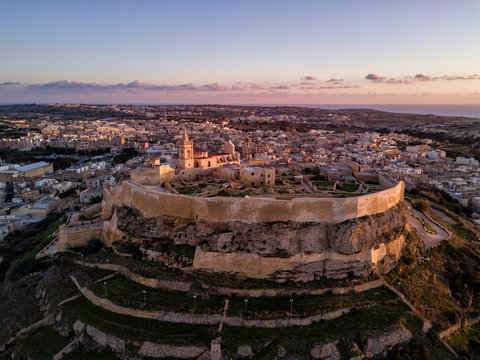 Aerial drone photo - The Gozo Citadel at sunset.  A medieval fortress in the city of Victoria (Rabat).  Island of Gozo, Malta.