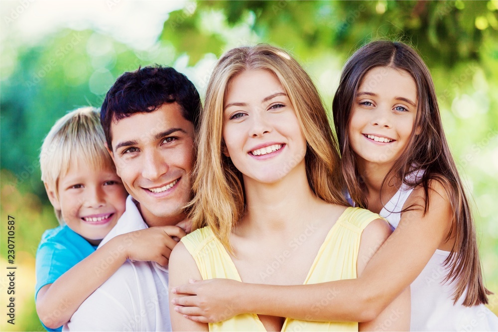 Wall mural Beautiful smiling Lovely family in park