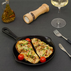 Roasted eggplant stuffed with vegetables, bacon and mozzarella cheese. Baked eggplant with cheese, meat and tomatoes.  