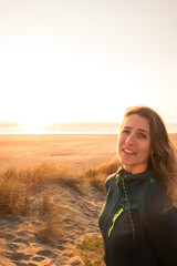 Woman smiling at sunset on the beach